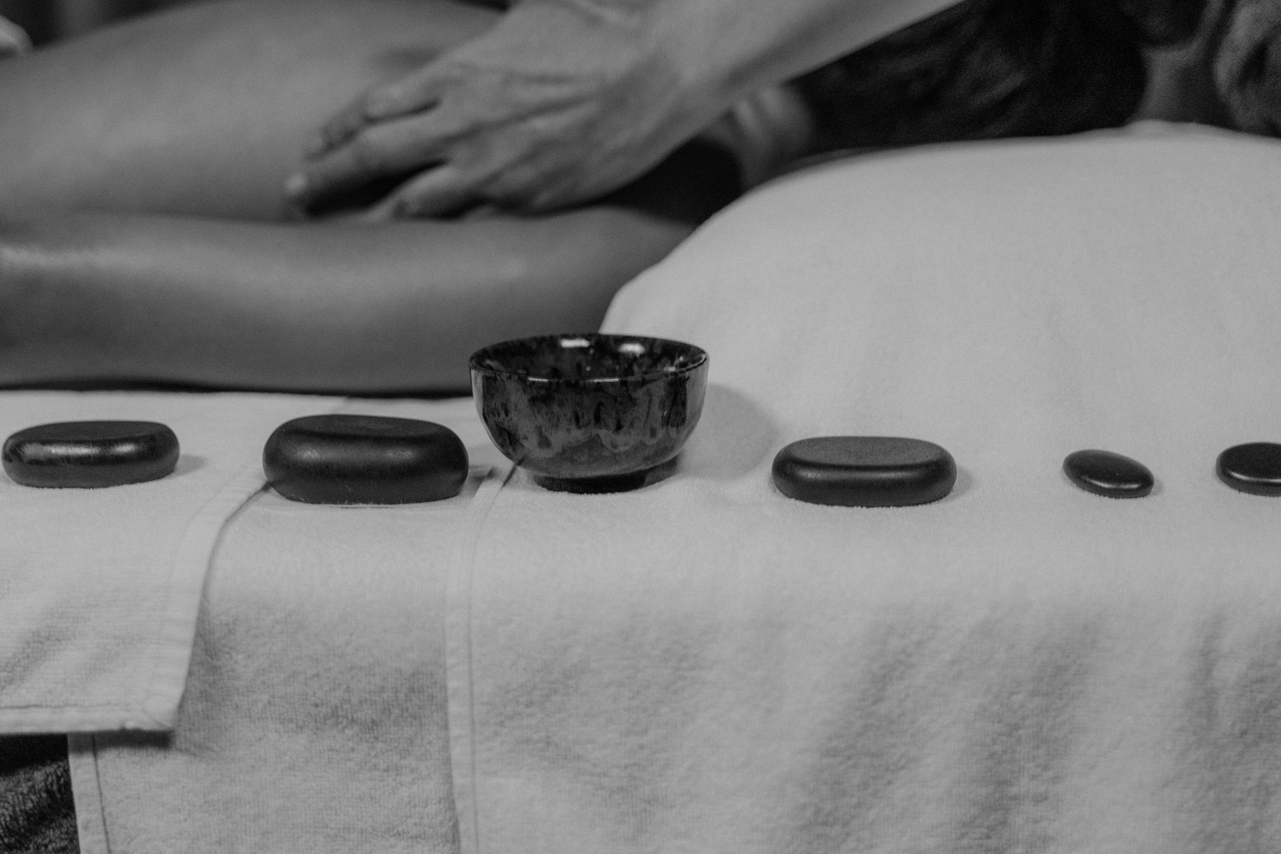 Client receiving hot stone massage at Juvenelle Day Spa